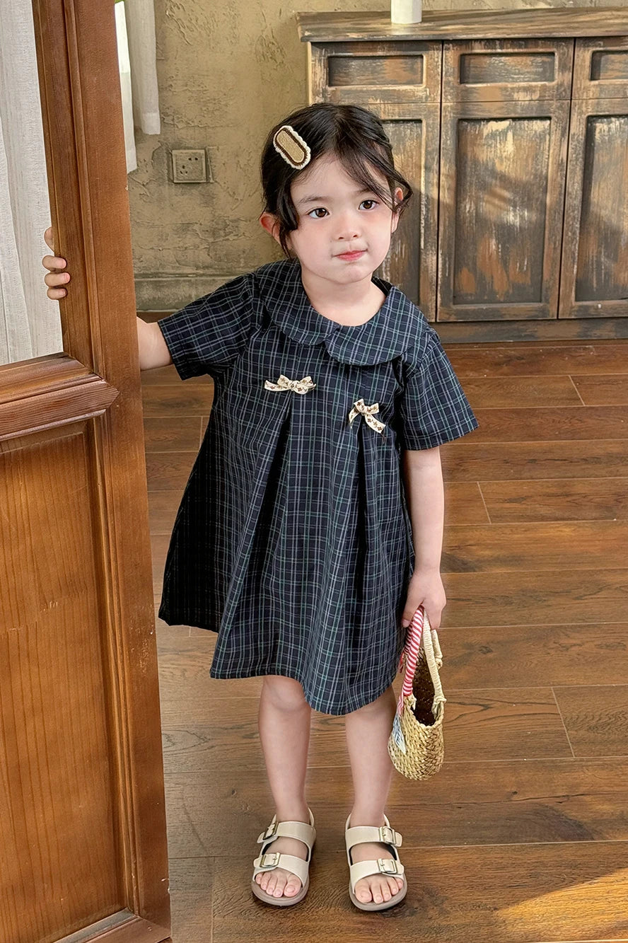 New-style fashionable girl's summer dress for little girls. A dress suitable for seaside vacations. A children's checkered dress