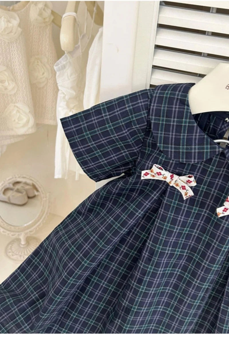 New-style fashionable girl's summer dress for little girls. A dress suitable for seaside vacations. A children's checkered dress