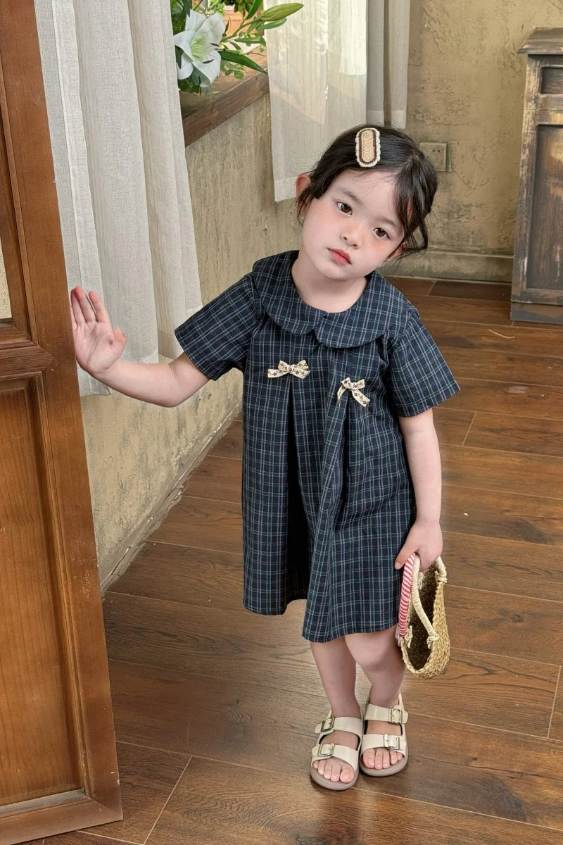 New-style fashionable girl's summer dress for little girls. A dress suitable for seaside vacations. A children's checkered dress