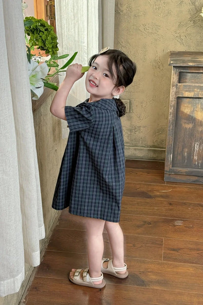 New-style fashionable girl's summer dress for little girls. A dress suitable for seaside vacations. A children's checkered dress