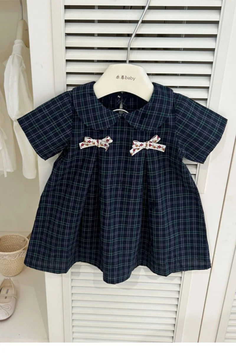 New-style fashionable girl's summer dress for little girls. A dress suitable for seaside vacations. A children's checkered dress