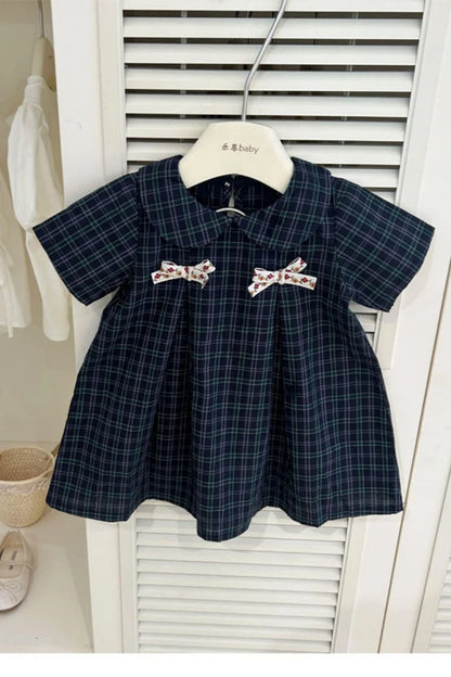 New-style fashionable girl's summer dress for little girls. A dress suitable for seaside vacations. A children's checkered dress