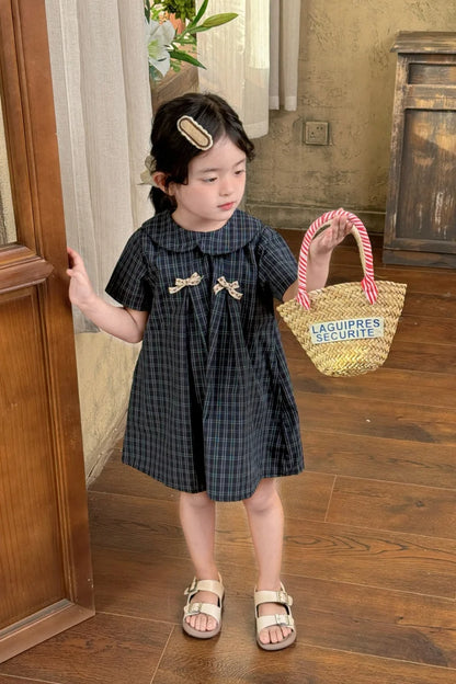 New-style fashionable girl's summer dress for little girls. A dress suitable for seaside vacations. A children's checkered dress