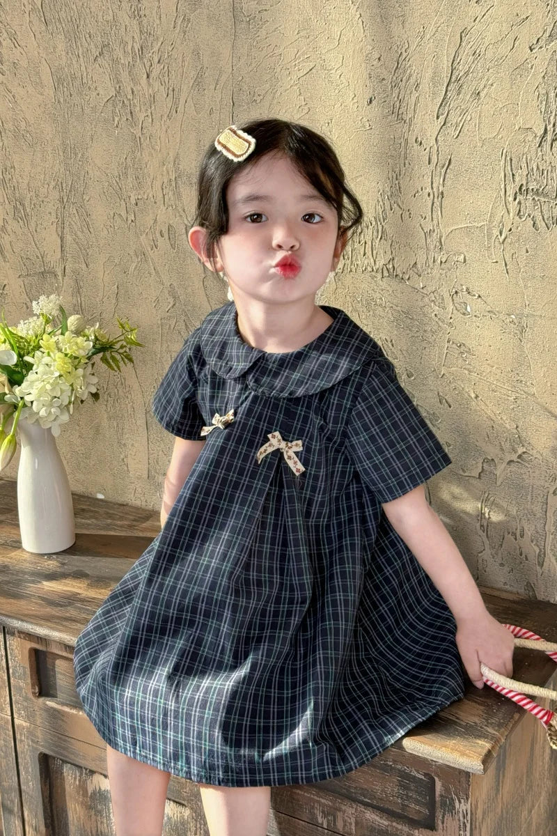New-style fashionable girl's summer dress for little girls. A dress suitable for seaside vacations. A children's checkered dress