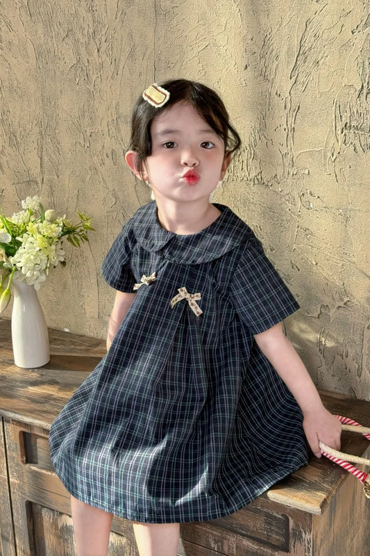 New-style fashionable girl's summer dress for little girls. A dress suitable for seaside vacations. A children's checkered dress